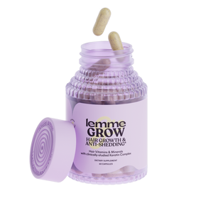 Purple jar of 'lemme Grow' hair growth and anti-shedding supplement with two capsules on a white background