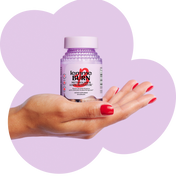 Hand holding a bottle of 'Lemme Burn' supplement against a purple heart-shaped background