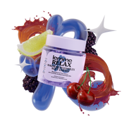 Jar of 'lemme RELAX' magnesium complex soft chews surrounded by fruit elements on a white background