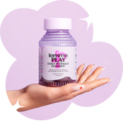 Bottle of daily intimacy gummies held in a hand against a purple background.