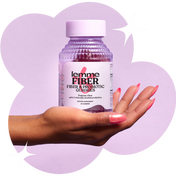 Hand holding a bottle of lemme Fiber & Probiotic Gummies against a light purple background